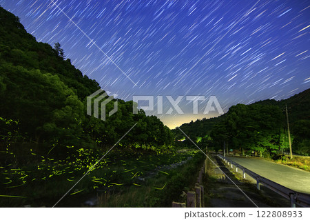 Fireflies and star trails dancing in a mountain stream 122808933