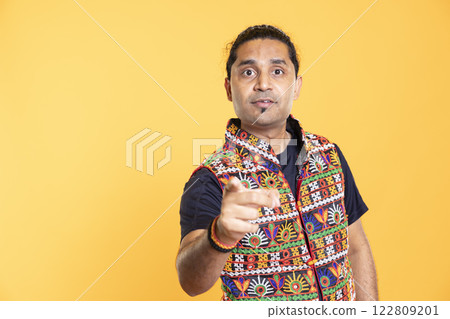 Stern man scolding friend as repercussion after fighting, isolated over studio background. Firm person with negative attitude in disagreement with mate, pointing finger and lecturing him after quarrel 122809201