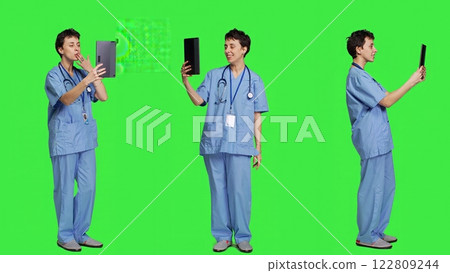 Healthcare specialist attending videocall connection with patient, discussing about treatment and checkup exam. Nurse chatting with a person on online telemedicine conference on tablet. Camera A. 122809244