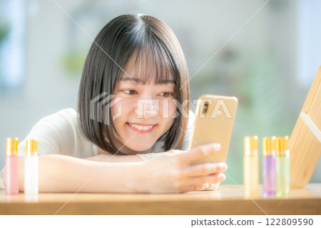 A young woman operating a smartphone A young woman operating a smartphone 122809590