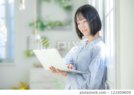 A young woman using a personal computer in the room A young woman using a personal computer in the room 122809609
