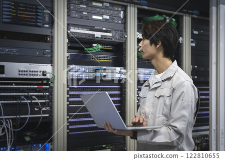 Server engineer image: Engineer working with a laptop computer profile Server engineer image: Engineer working with a laptop computer profile 122810655