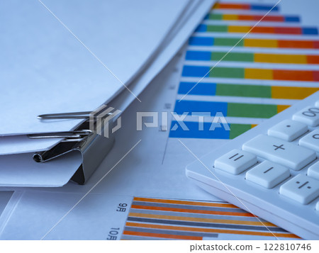 Graphs, documents and calculator on the table Graphs, documents and calculator on the table 122810746