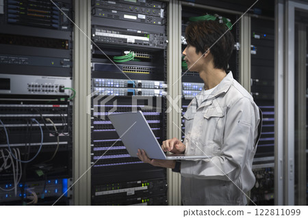 Server engineer image: Engineer working with a laptop computer profile 122811099