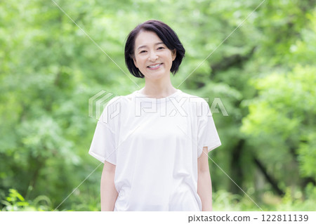 Middle-aged woman walking in the park Middle-aged woman walking in the park 122811139
