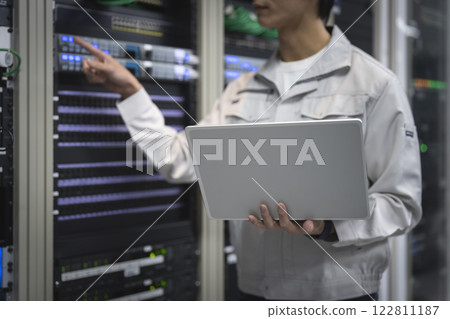 Server engineer image: Hands of a young man working on a laptop 122811187