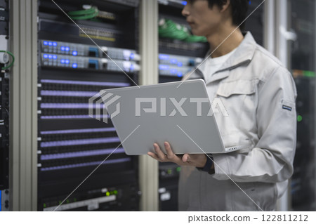 Server engineer image: Hands of a young man working on a laptop 122811212