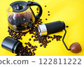 Coffee beans, coffe grinder and brewed cofee on yellow background 122811222