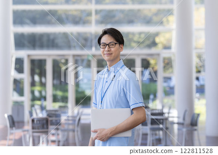 Male facility staff image in his 40s smiling at the camera 122811528