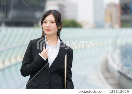 Businesswoman in a suit, newcomer, Nagoya Sakae OASIS21, smiling at the water spaceship 122812059