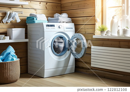 A laundry room features a washing machine with an open door, surrounded by neatly stacked towels and natural light. A laundry room features a washing machine with an open door, surrounded by neatly stacked towels and natural light. 122812108