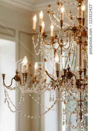 Luxurious gold chandelier. The lamp decorates a gorgeous mansion. Luxurious gold chandelier. The lamp decorates a gorgeous mansion. 122812427