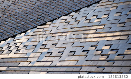 Interlocking reflective tiles with undulating curves, ideal for contemporary design portfolios, architectural branding, or urban innovation concepts. Interlocking reflective tiles with undulating curves, ideal for contemporary design portfolios, architectural branding, or urban innovation concepts. 122813280