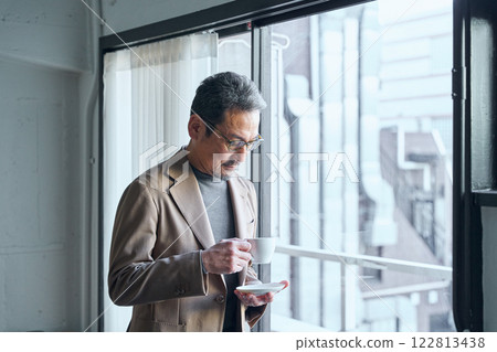 man drinking coffee by the window 122813438