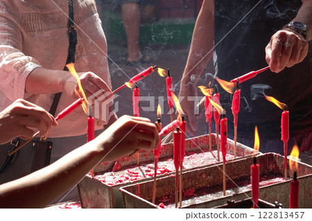 Devotees lighting candle inside a chinese taoist temple. 122813457