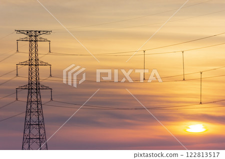 Sunset and electricity transmission tower 122813517