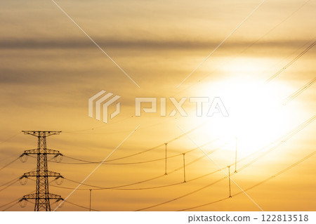Sunset and electricity transmission tower 122813518