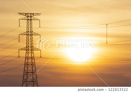 Sunset and electricity transmission tower 122813522