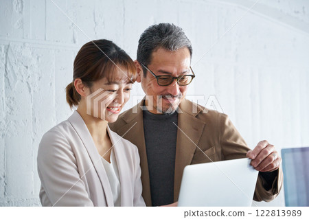 一名中年男子走近一名女子並與她交談 一名中年男子走近一名女子並與她交談 122813989