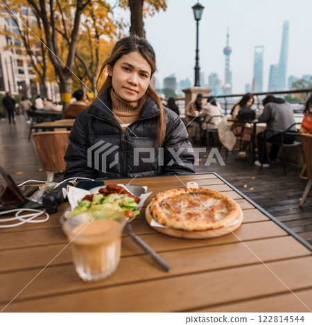 woman traveler visiting in Shanghai, China. Happy Female Tourist enjoy eating and drinking in Restaurant and Coffee bar. landmark and popular for tourism attractions. Travel and vacation concept woman traveler visiting in Shanghai, China. Happy Female Tourist enjoy eating and drinking in Restaurant and Coffee bar. landmark and popular for tourism attractions. Travel and vacation concept 122814544