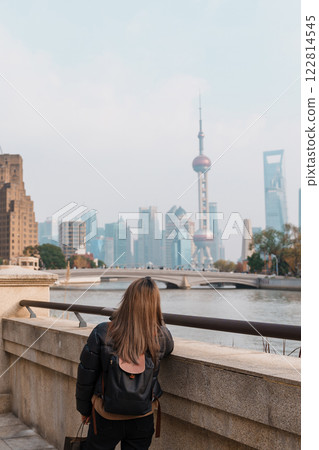 woman traveler visiting in Shanghai, China. Happy Female Tourist sightseeing Oriental Pearl Tower and Waibaidu Bridge view. landmark and popular for tourism attractions. Travel and vacation concept woman traveler visiting in Shanghai, China. Happy Female Tourist sightseeing Oriental Pearl Tower and Waibaidu Bridge view. landmark and popular for tourism attractions. Travel and vacation concept 122814545