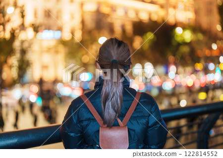 woman traveler visiting in Shanghai, China. Happy Female Tourist sightseeing Shanghai view in The Bund of Shanghai at night. landmark and popular for tourism attractions. Travel and Vacation concept woman traveler visiting in Shanghai, China. Happy Female Tourist sightseeing Shanghai view in The Bund of Shanghai at night. landmark and popular for tourism attractions. Travel and Vacation concept 122814552