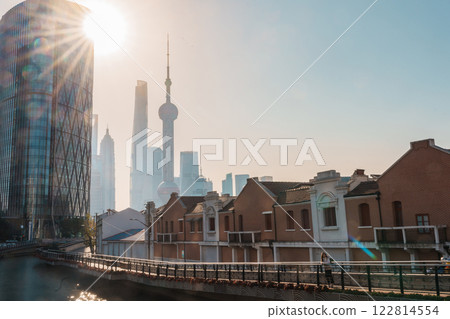 woman traveler visiting in Shanghai, China. Female Tourist with backpack sightseeing Shanghai view of Lujiazui in Hongkou Gang canal of Shanghai. landmark and popular for tourism attraction 122814554