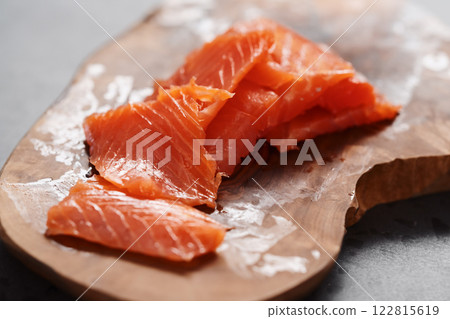 Smoked salted salmon slices on wood board Smoked salted salmon slices on wood board 122815619