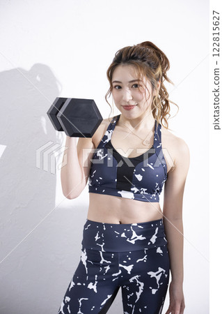 Young woman doing physical exercise Young woman doing physical exercise 122815627