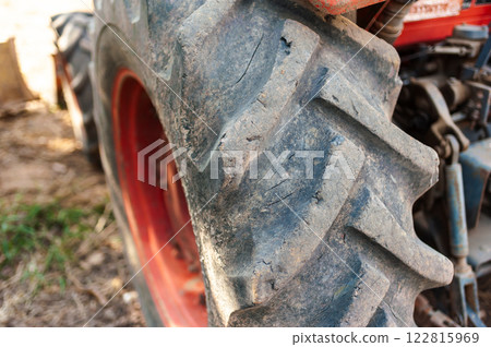 Tractor tire close-up farm field agriculture natural environment ground level industrial concept Tractor tire close-up farm field agriculture natural environment ground level industrial concept 122815969