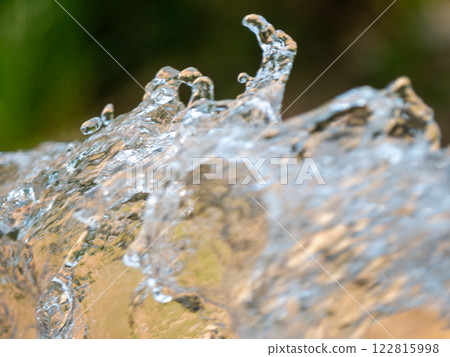Dynamic water splash close-up exploring fluid motion in a vibrant outdoor environment 122815998