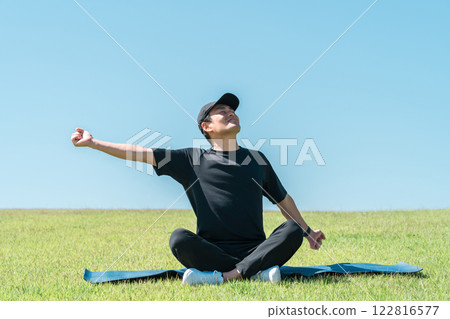 A man refreshing in the park (exercise, pilates, workout, yoga, sports) A man refreshing in the park (exercise, pilates, workout, yoga, sports) 122816577