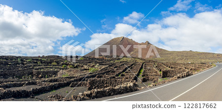 ** Scenic Volcanic Landscape with Stone Walls and Mountains - ** 122817662