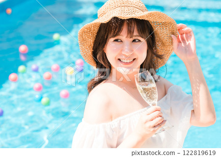 年輕的亞洲女性在泳池邊喝香檳(度假村度假) 年輕的亞洲女性在泳池邊喝香檳(度假村度假) 122819619