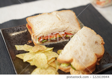 Homemade sardine sanwich with potato chips. Homemade sardine sanwich with potato chips. 122819944