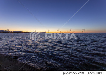Hanawa Pier and offshore wind power tower at sunset 122820099