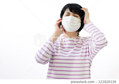 Middle-aged woman wearing a mask 122820130