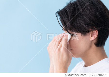 Image of a man holding tissue to his eyes (stock photo) 122820656
