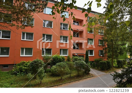 Original prefabricated houses on a housing estate from the communist era in Eastern and Central Europe after reconstruction.. Facade of a modern apartment building with windows and balconies. Czech 122821239