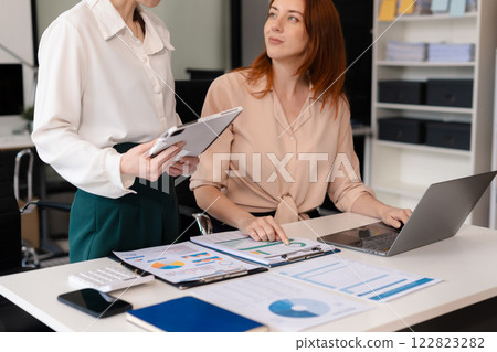 Diverse Business Team Discusses Financial Project Analysis in Meeting. 122823282