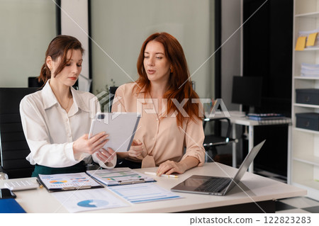 Diverse Business Team Discusses Financial Project Analysis in Meeting. 122823283