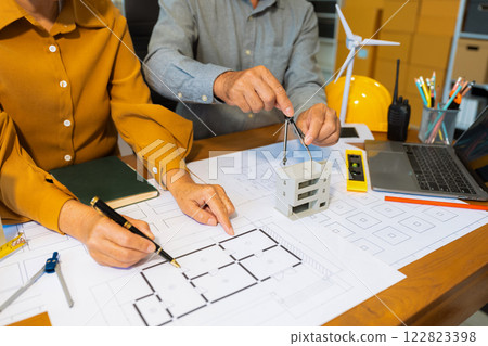 Architect team working with blueprints for sketching a construction project. 122823398