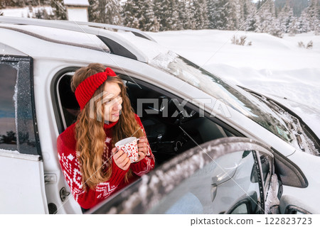 Woman Drinking Coffee during Winter Road Trip Woman Drinking Coffee during Winter Road Trip 122823723