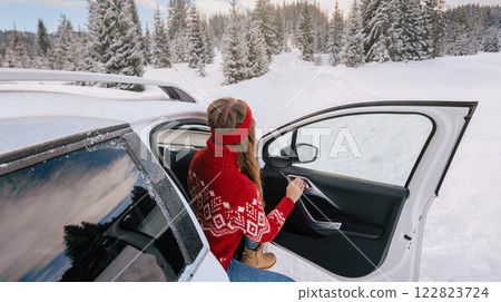 Woman Getting out of Car in Snowy Winter Forest Woman Getting out of Car in Snowy Winter Forest 122823724