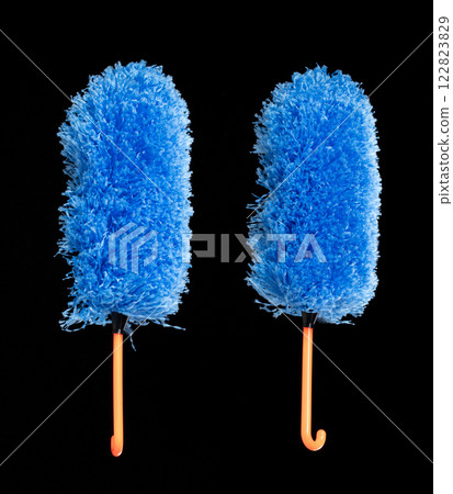 Blue microfiber Duster stick made from synthetic to clean house dust and web. Room Ceiling and window covered with dust bunnies, cobweb cleaned by microfiber duster stick. Black background isolated Blue microfiber Duster stick made from synthetic to clean house dust and web. Room Ceiling and window covered with dust bunnies, cobweb cleaned by microfiber duster stick. Black background isolated 122823829