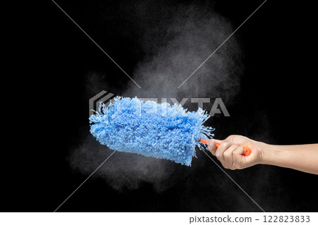 Blue microfiber Duster stick made from synthetic to clean house dust and web. Room Ceiling and window covered with dust bunnies, cobweb cleaned by microfiber duster stick. Black background isolated Blue microfiber Duster stick made from synthetic to clean house dust and web. Room Ceiling and window covered with dust bunnies, cobweb cleaned by microfiber duster stick. Black background isolated 122823833