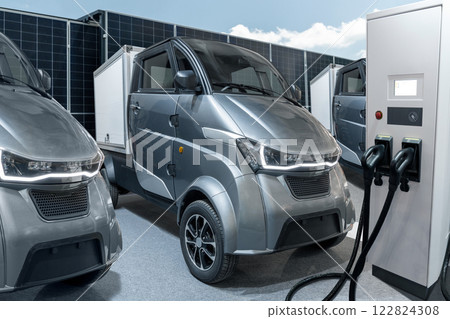 Electric vehicles charging station on a background of a small city delivery trucks 122824308