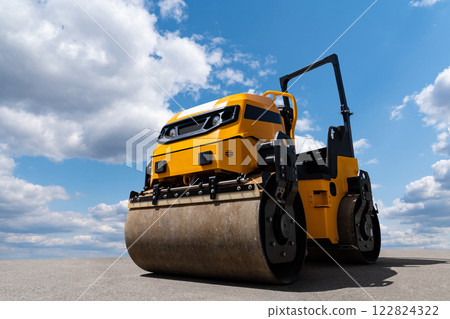 Yellow road roller machine on a background of blue sky 122824322