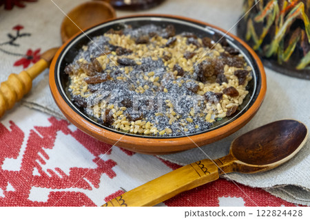 Christmas kutia with poppy seeds and raisins. Wooden spoon. Traditional Kutya sweet cereal in Ceramic Bowl food Christmas kutia with poppy seeds and raisins. Wooden spoon. Traditional Kutya sweet cereal in Ceramic Bowl food 122824428