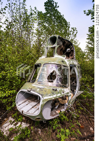 Destroyed military old helicopter at the airfield. Soviet Union army technique 122824708